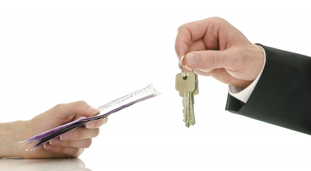 man exchanging money for keys