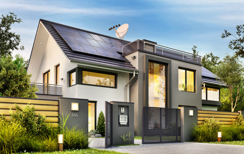 Beautiful modern house with garden and solar panels on the gable roof. 3d rendering