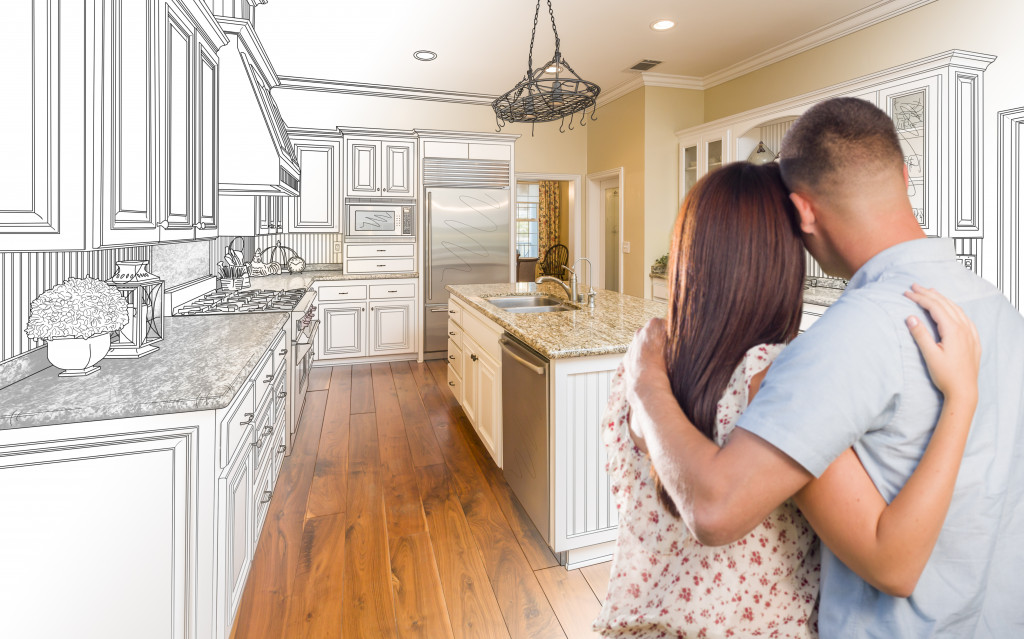 couple embracing while envisioning the house layout