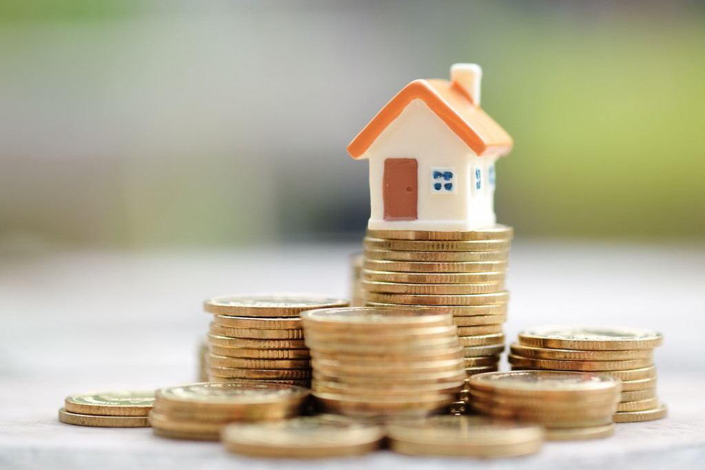 property investment house on top of coins