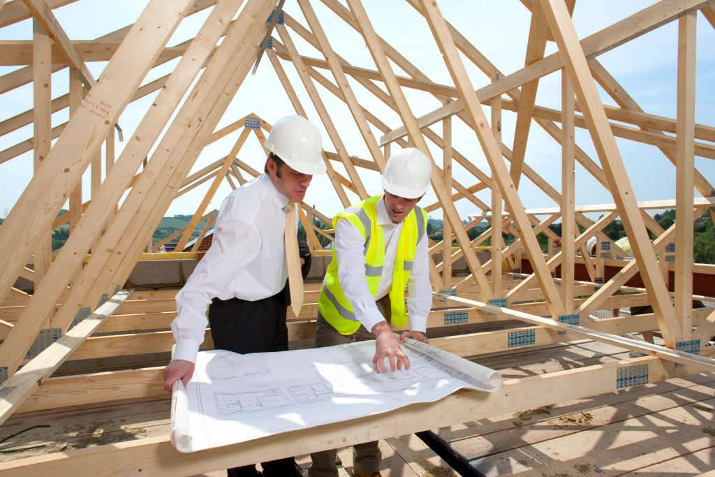 A couple of construction professionals discussing a building's blueprint